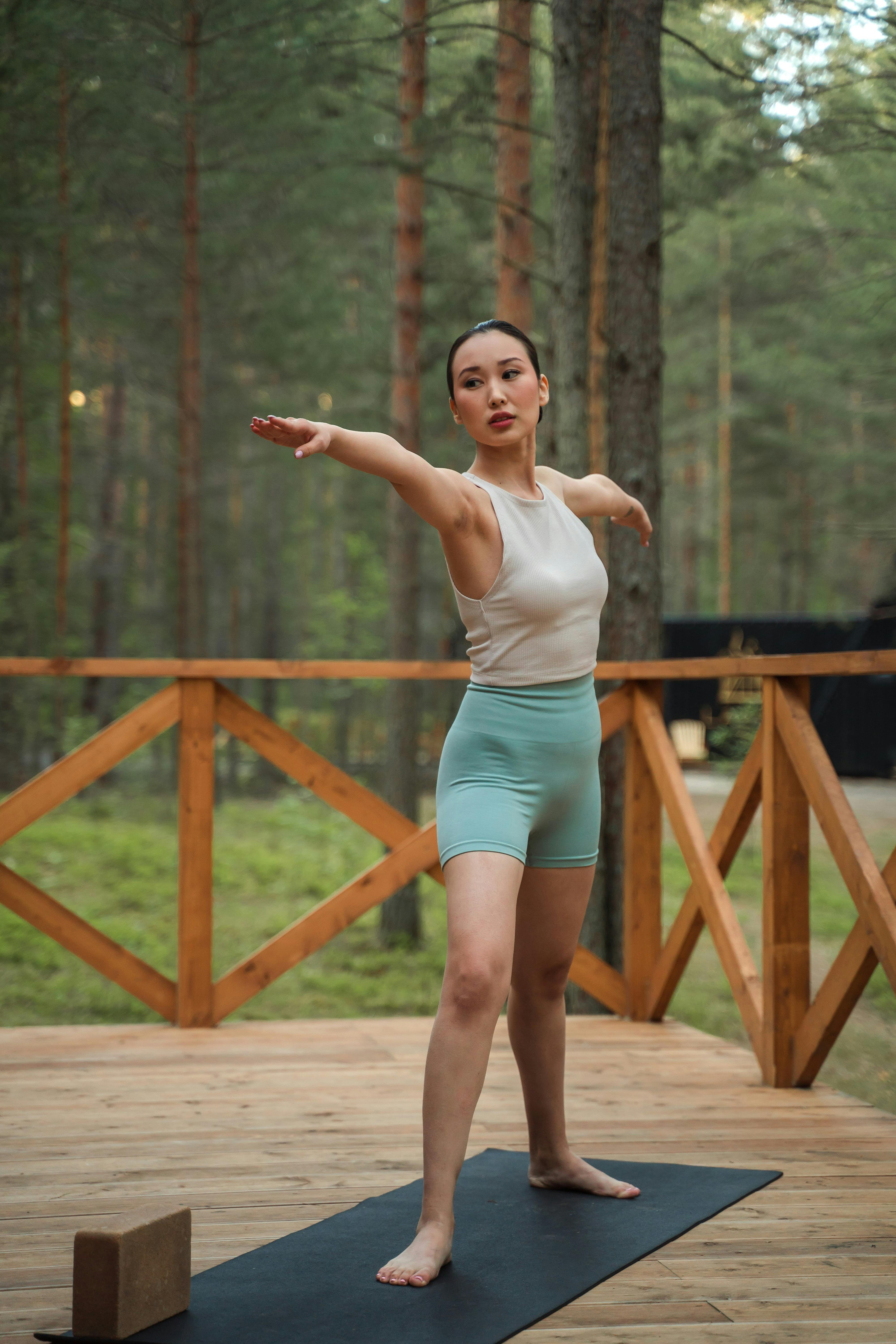 woman standing on yoga mat