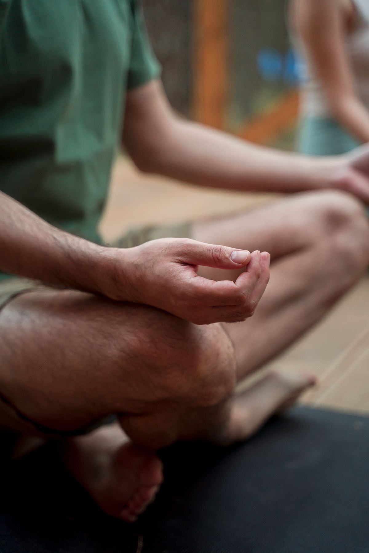 Close-up of a hand resting in a calm meditation gesture on the knee