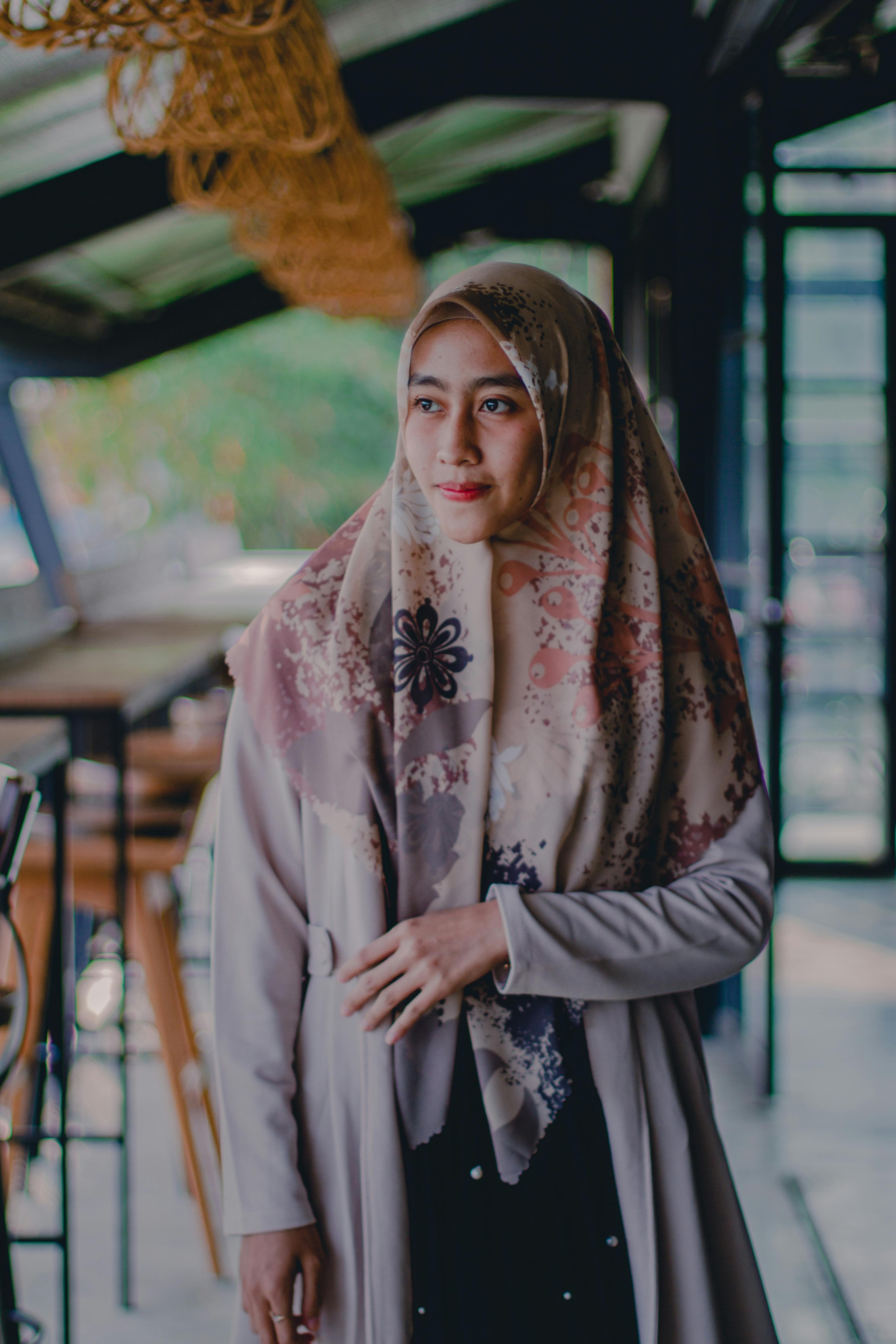 Black woman in hijab standing near wall · Free Stock Photo