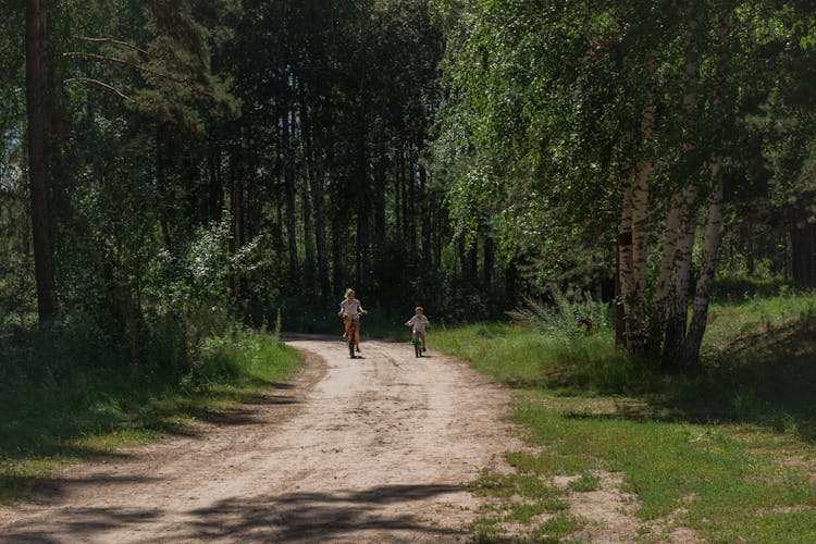 Photo Of A Woman And Her Son Riding Bikes Together