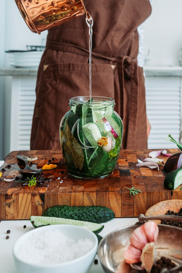 Water Pouring In Clear Glass Jar With Green Vegetable