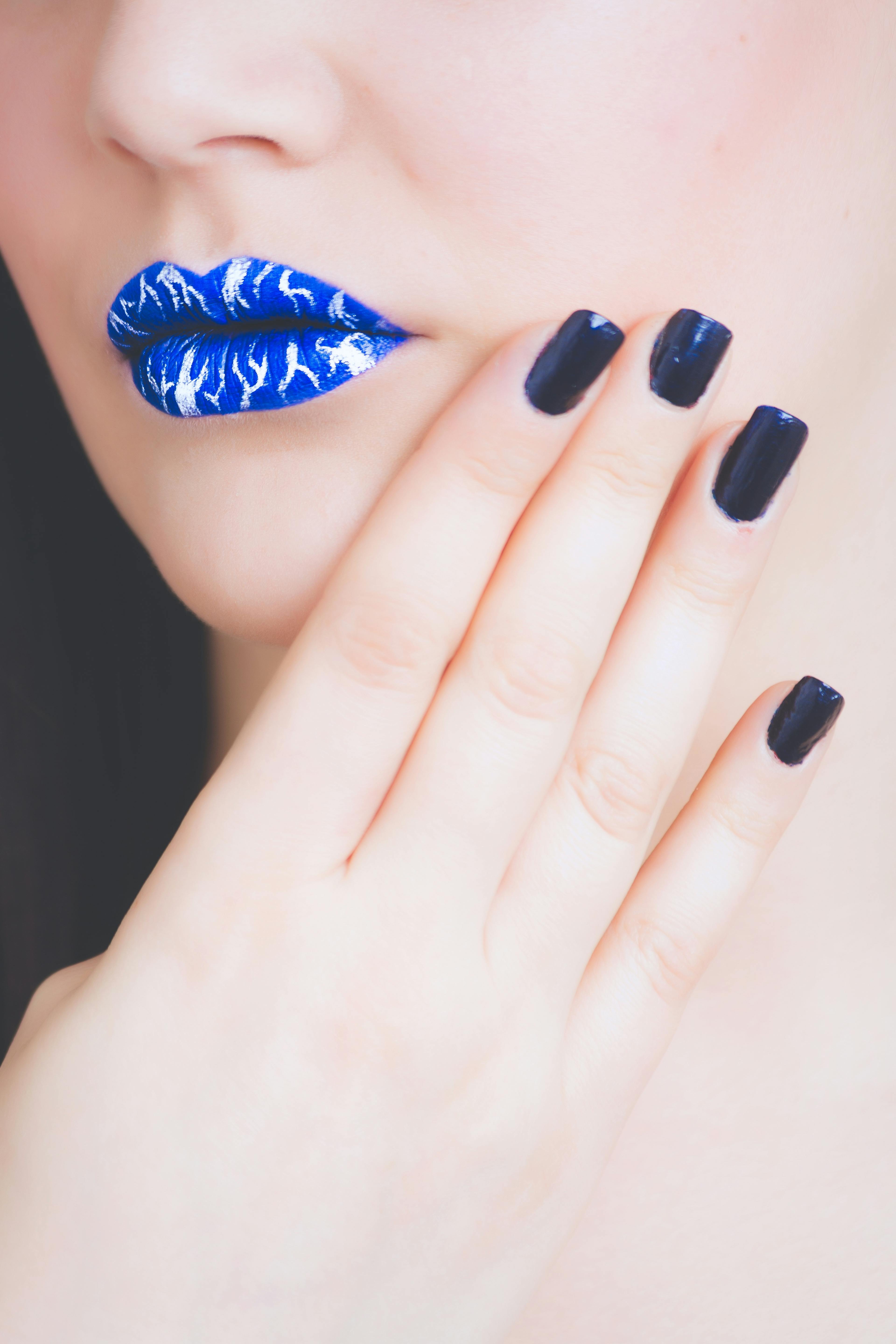 Woman Wearing Blue and White Lipstick With Black Manicure
