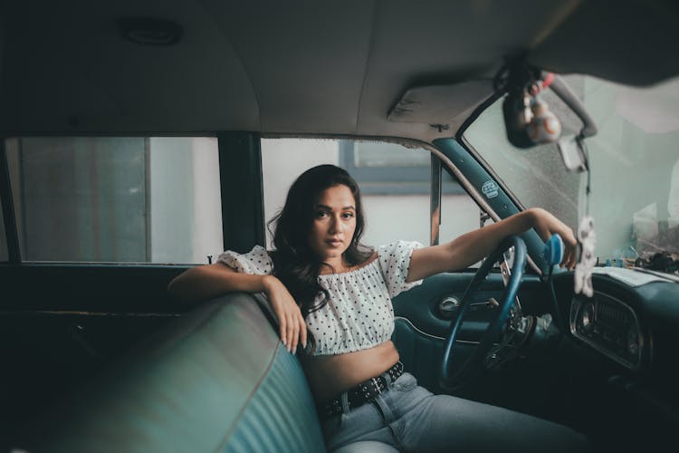 Woman In White Polka Dot Crop Top Sitting On Driver Seat