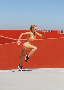 Woman in athletic wear jogging energetically against a vivid urban backdrop.