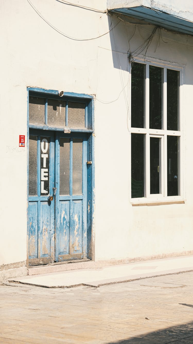 Blue Wooden Door On White Concrete Building