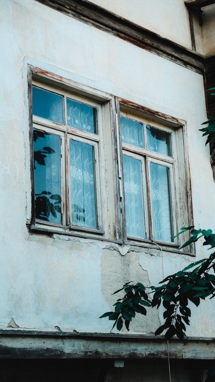 White Wooden Frames Of Glass Windows On Concrete Wall