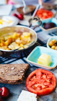 Colorful breakfast spread featuring fresh vegetables, cheese, and a variety of food items.