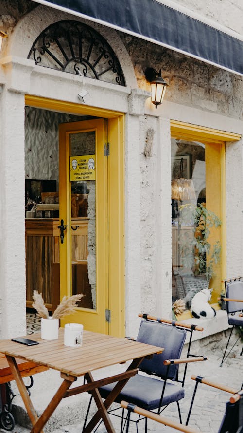 Wooden Chairs and Tables Outside the Restaurant 