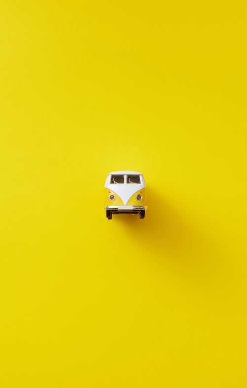 Yellow and White Toy Car on Yellow Background