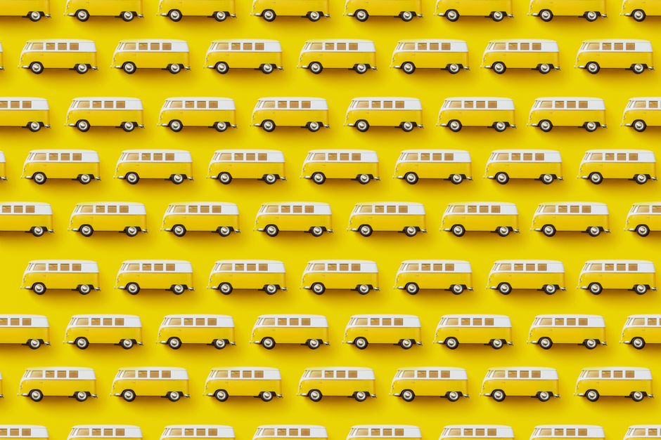 A vibrant design featuring a repeating pattern of yellow and white retro vans on a bright yellow background.
