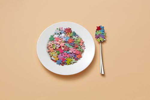 Free Puzzle Pieces On Plate and Spoon Stock Photo