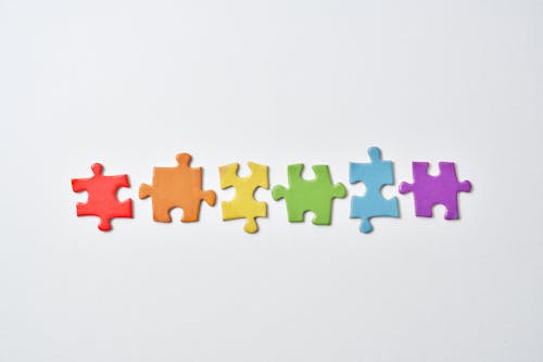 A Row of Puzzle Pieces in White Background