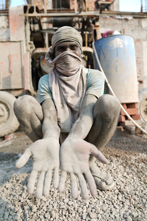 A Construction Worker With Dirty Hands