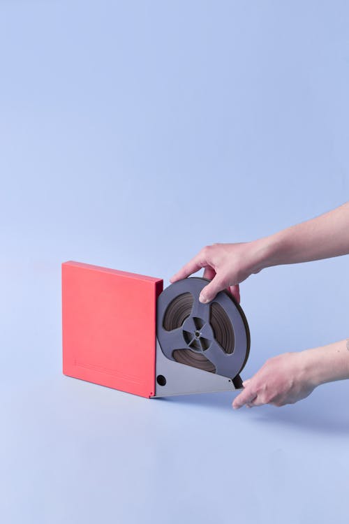 A Person Holding a Magnetic Audio Tape