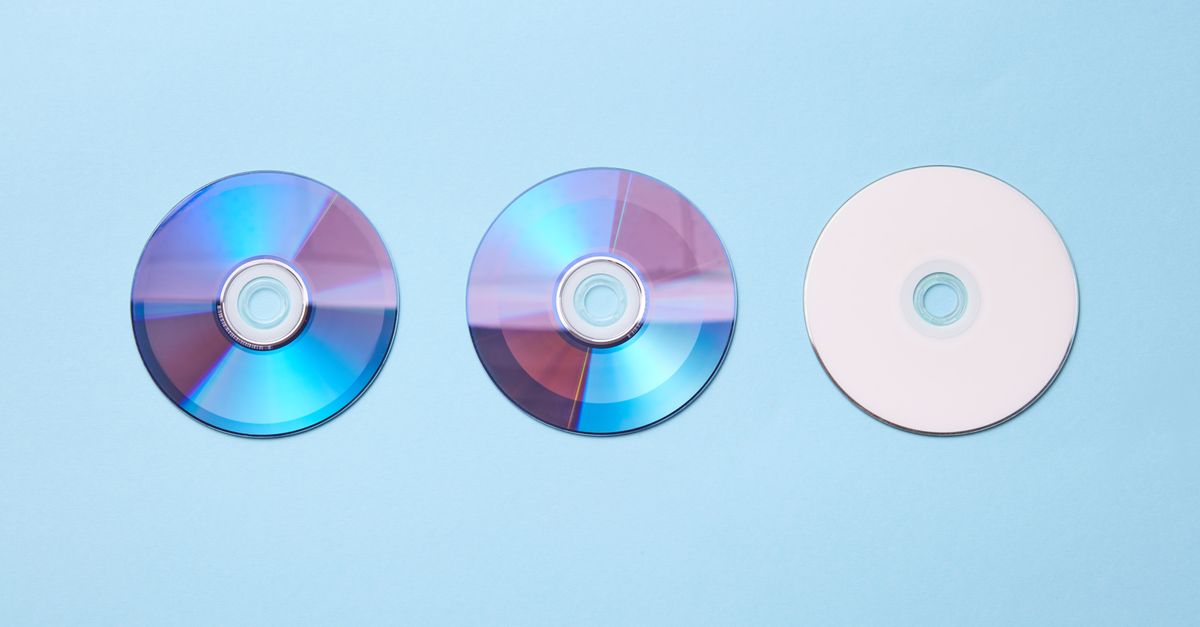 Three classic compact discs with a nostalgic tone on a pastel blue background.