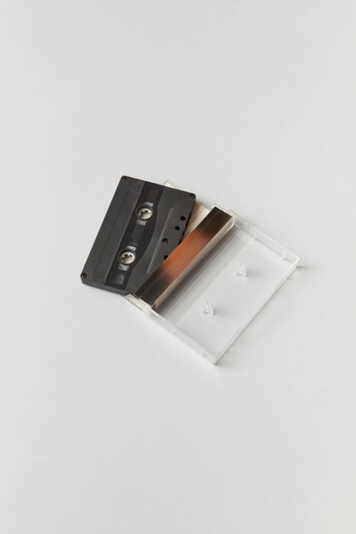 Free A minimalistic shot of a vintage black cassette tape with case on a white background. Stock Photo