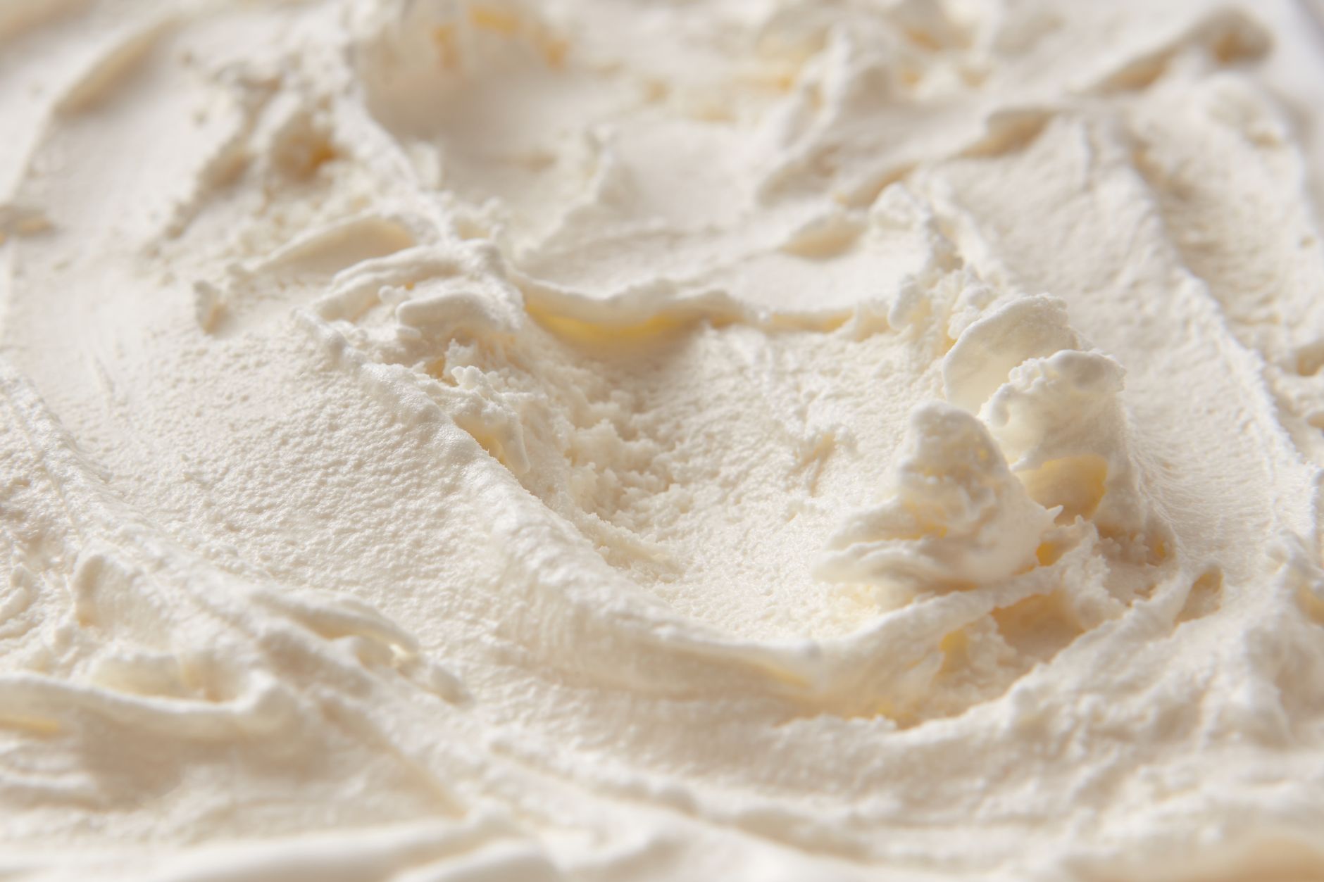 Whipped cream being folded with condensed milk for ice cream