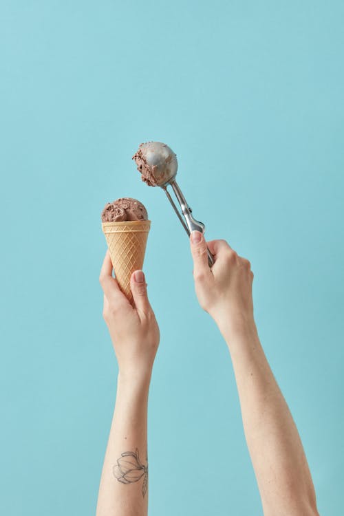 Person Holding Ice Cream Cone With Ice Cream