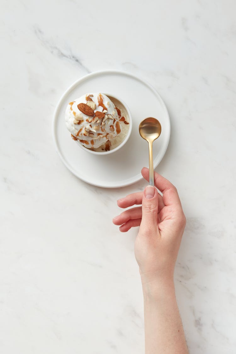 Hand Holding A Golden Spoon 