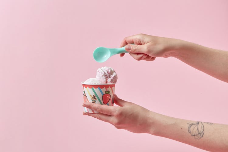 Hand Holding Cup Of Ice Cream