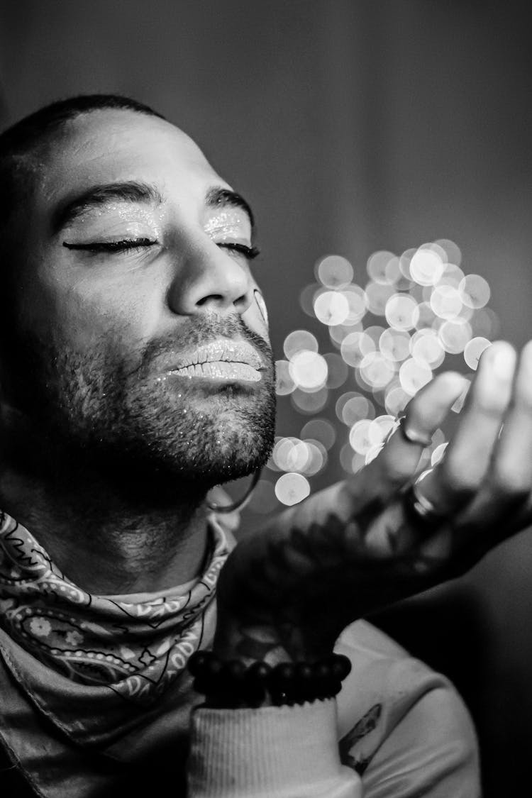 Black And White Portrait Of Man Holding Scattered Light