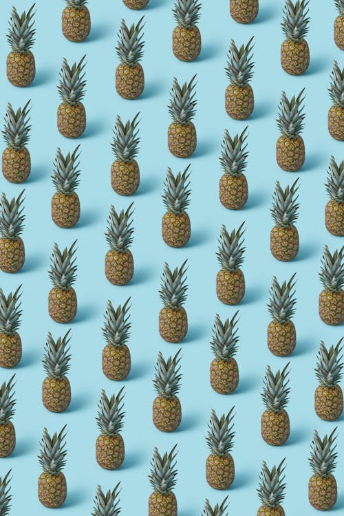 Free Pineapple on a Turquoise Surface Stock Photo