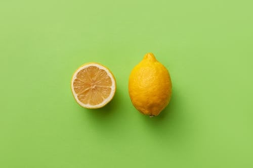 Studio Shot of a Whole and a Halved Lemon