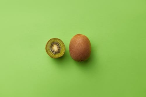 Kiwi Fruit on Green Surface