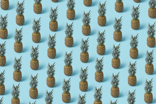 Fresh Pineapple Fruits on Turquoise Surface