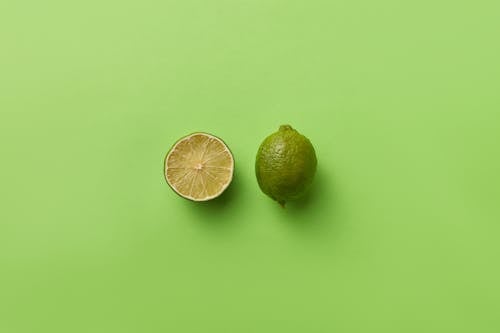 Photo of a Sliced Lime on a Green Surface