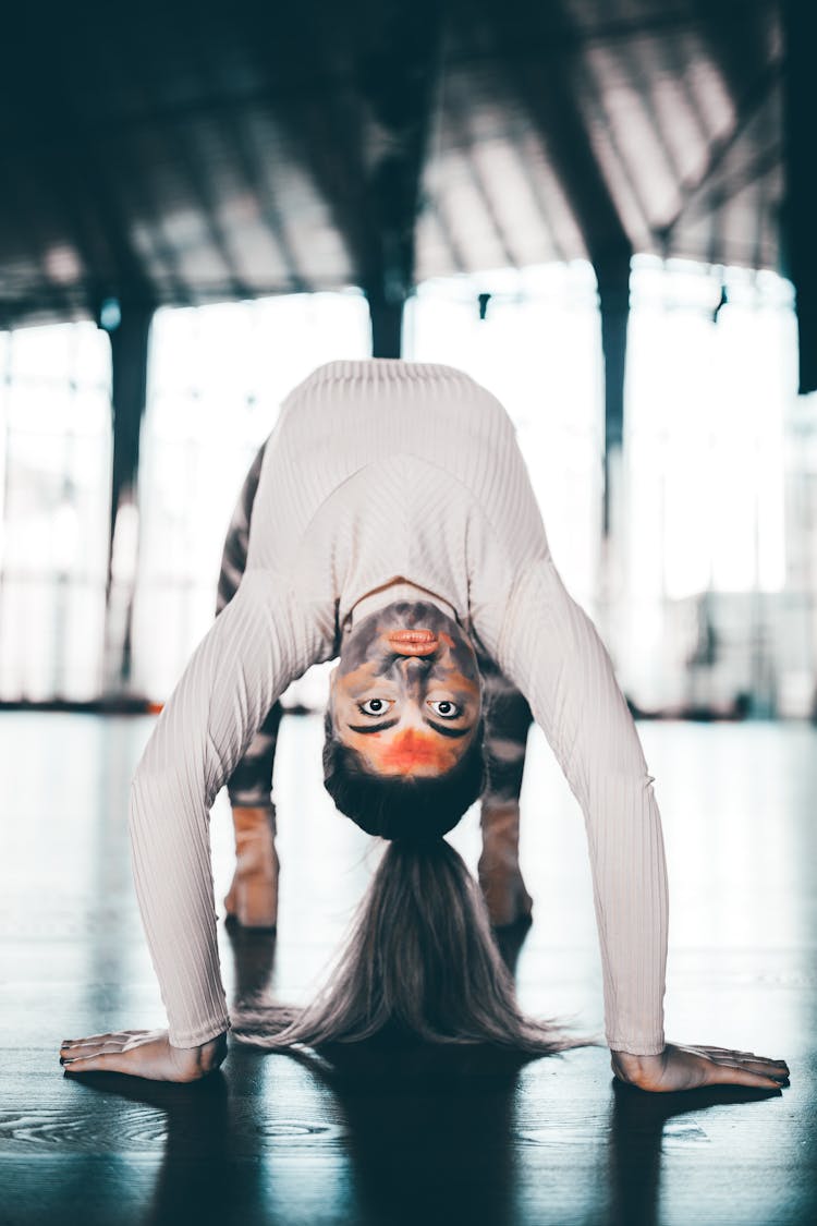 Woman In Black Face Paint Doing Back Bend