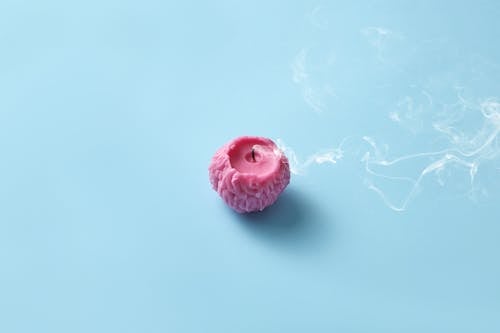 Photograph of a Pink Candle with Smoke