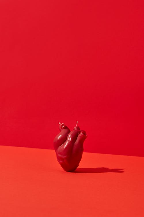 Heart Shaped Candle in Red Background