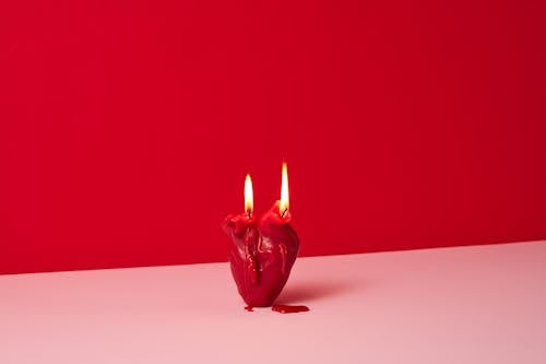 Red Lighted Candle on a White Surface