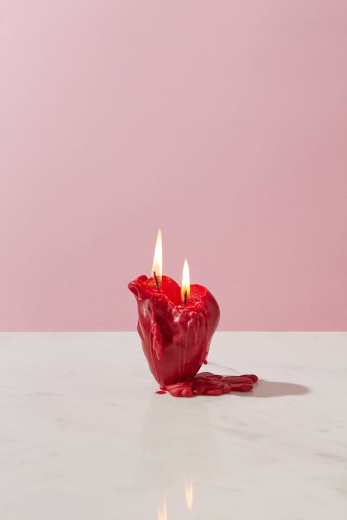 Reed Lighted Candle on White Surface