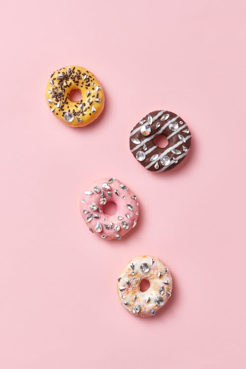 Close-Up Shot of Doughnuts on a Pink Surface