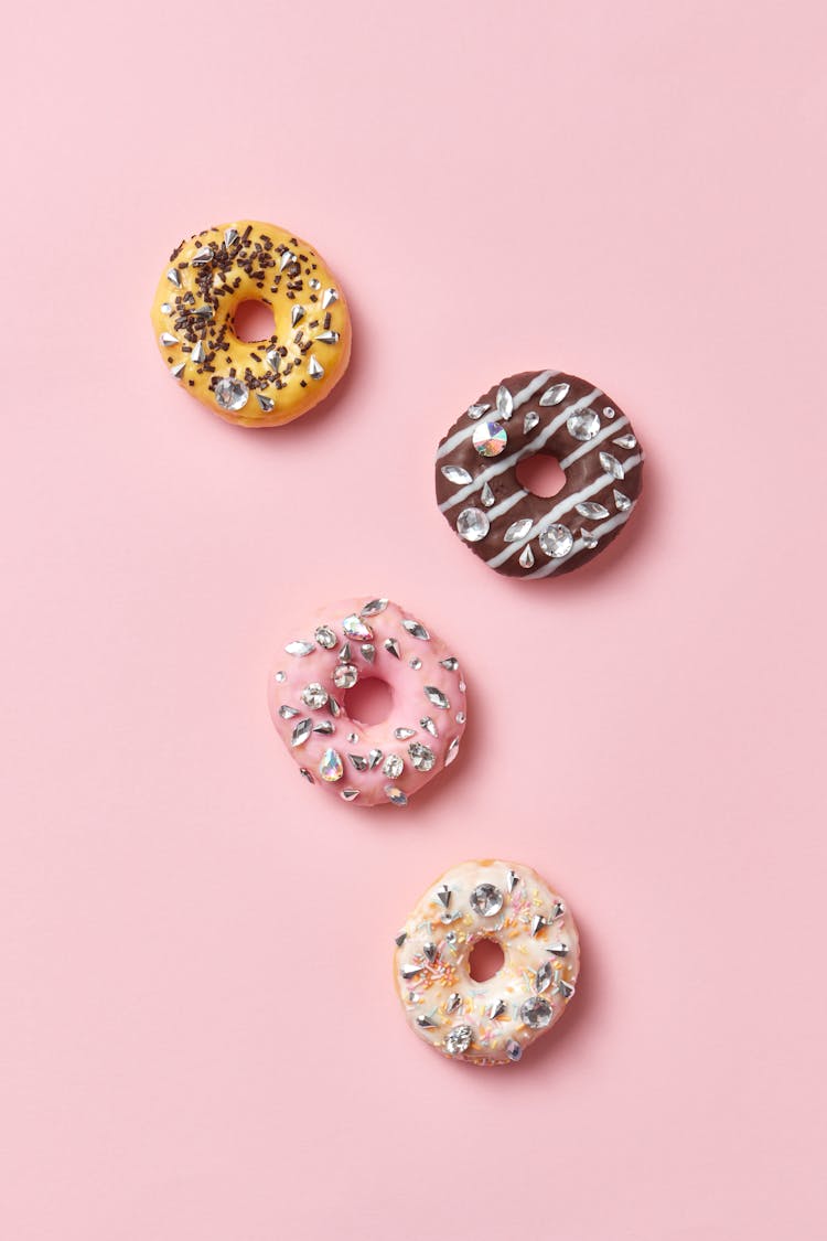 Close-Up Shot Of Doughnuts On A Pink Surface