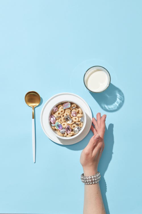 Bowl with Sugar Cereal and a Glass of Milk 