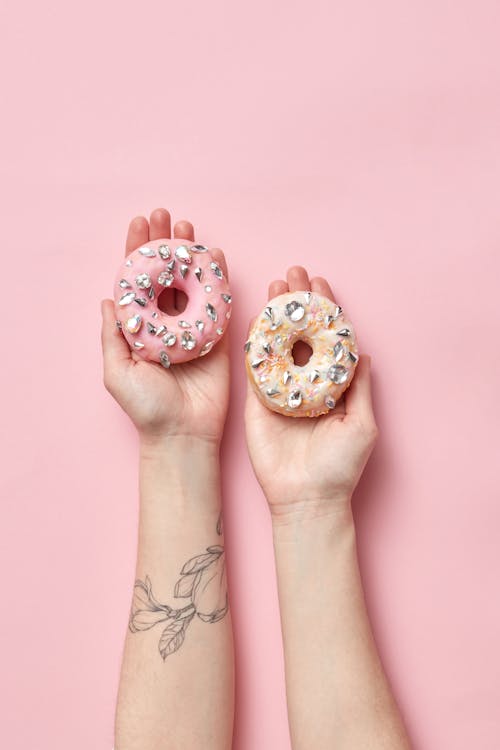 Overhead Shot of Donuts with Diamonds on a Person's Hands