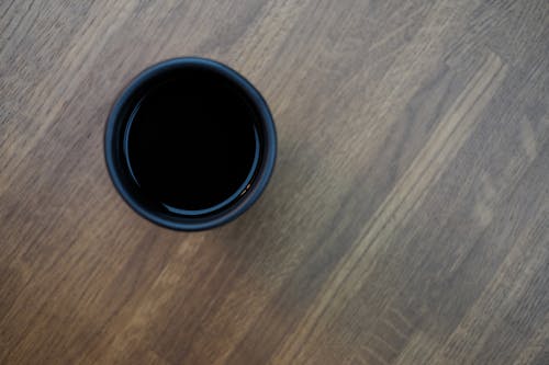 Free Black Plastic Cup in Top of Brown Wooden Surface Stock Photo