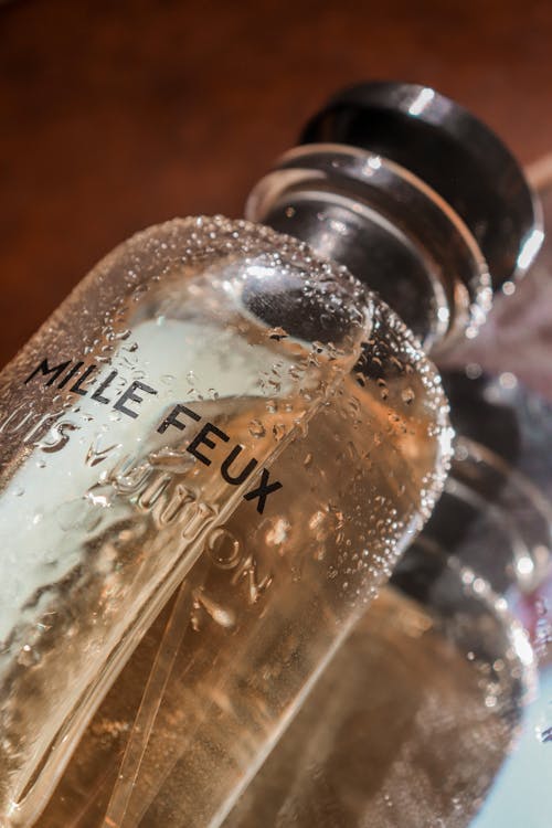 Free Close-Up Photograph of a Wet Perfume Bottle Stock Photo