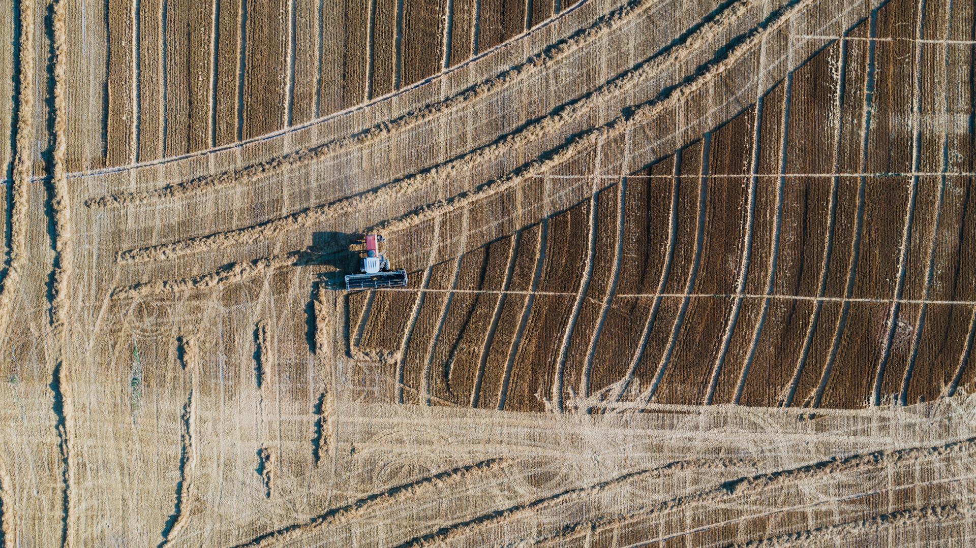 A Tractor Plowing the Field