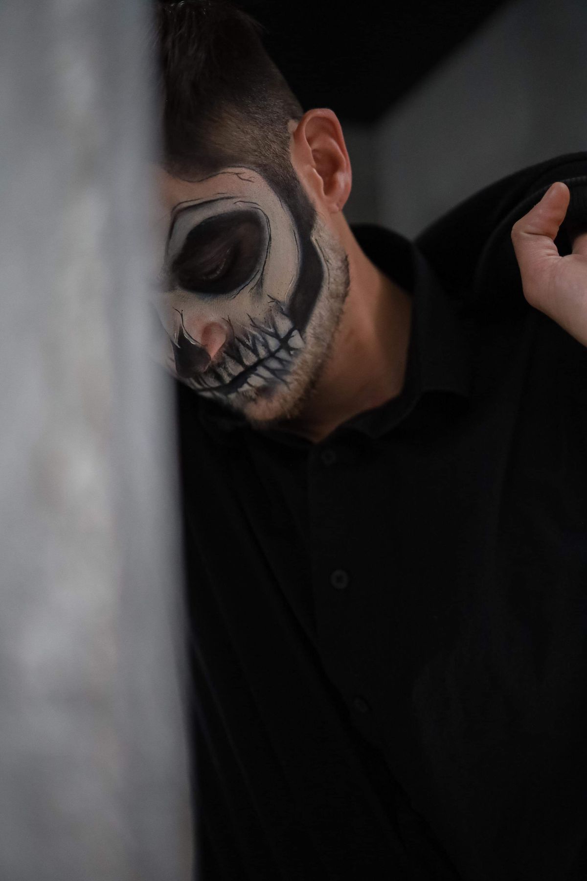 Dark skull half-face Halloween makeup portrait