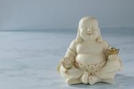 White Ceramic Angel Figurine on White Textile