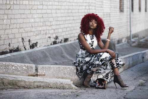 Red Haired Woman in White and Black Floral Sleeveless Maxi Dress