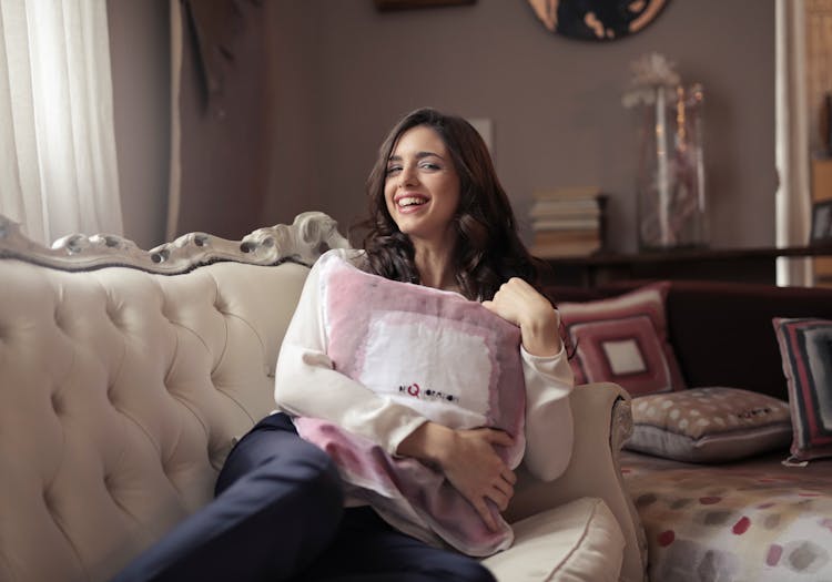 Photo Of A Woman Sitting On The Couch