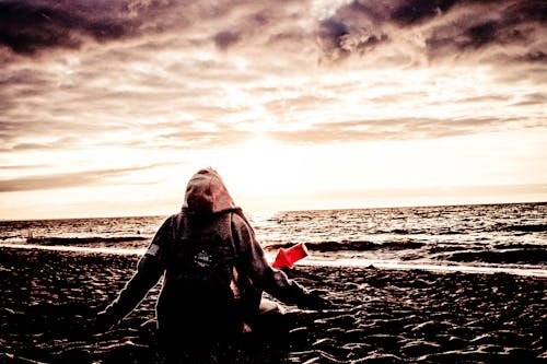 Person Sitting on Shore