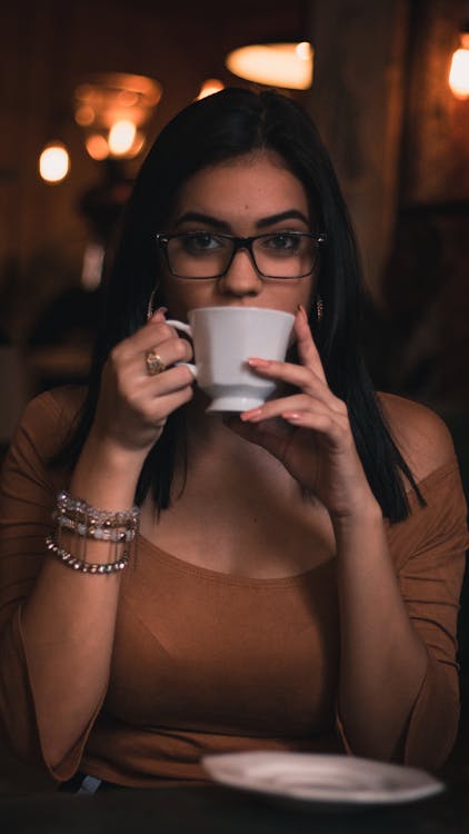 Woman Wearing Brown Scoop-neck Quarter-sleeved Top Holding White Ceramic Mug