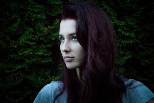 Women's Gray Shirt Beside Green Leafed Plant Close-up Photo