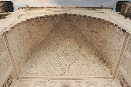 Low angle view of ornate Islamic architectural ceiling with intricate carvings in Aurangabad, India.